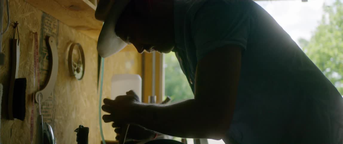 Hat maker crafting a handmade hat in a workshop