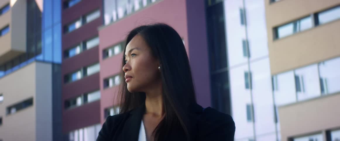 A woman is standing in a downtown city