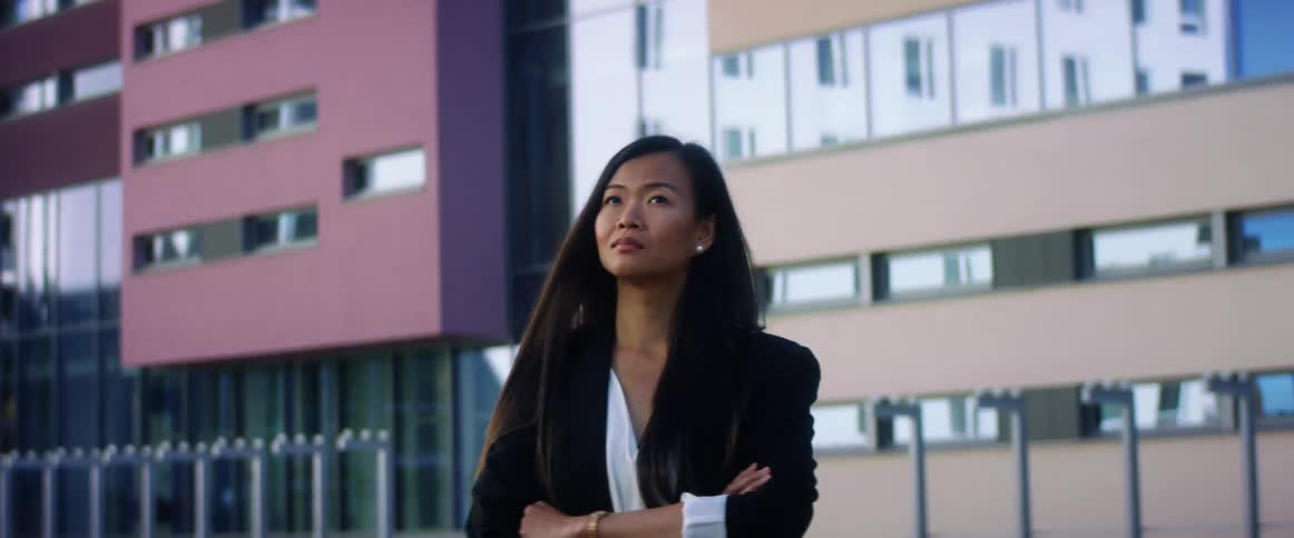 Young business woman stands otuside a building in the city