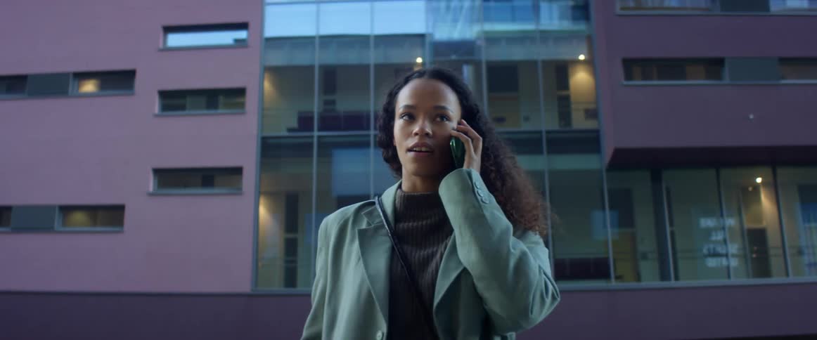 A woman is standing in an urban city
