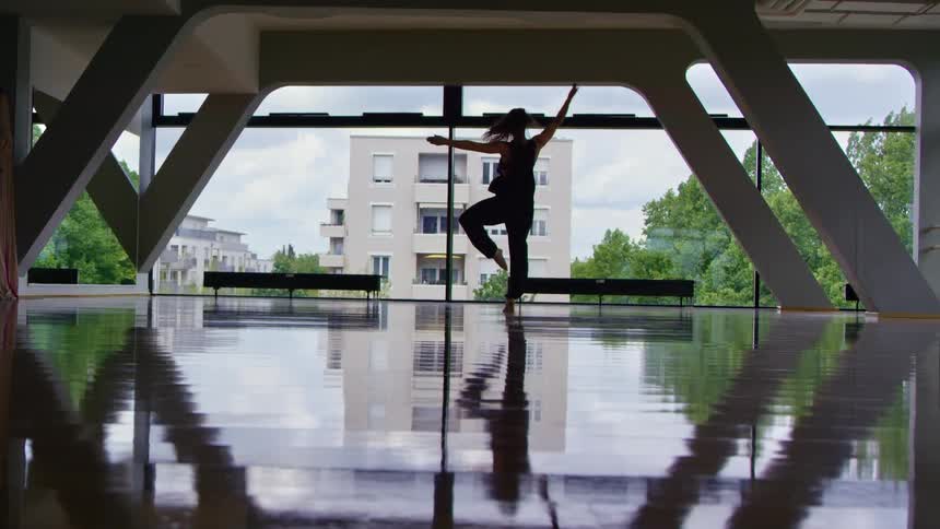 A woman is dancing in an empty room