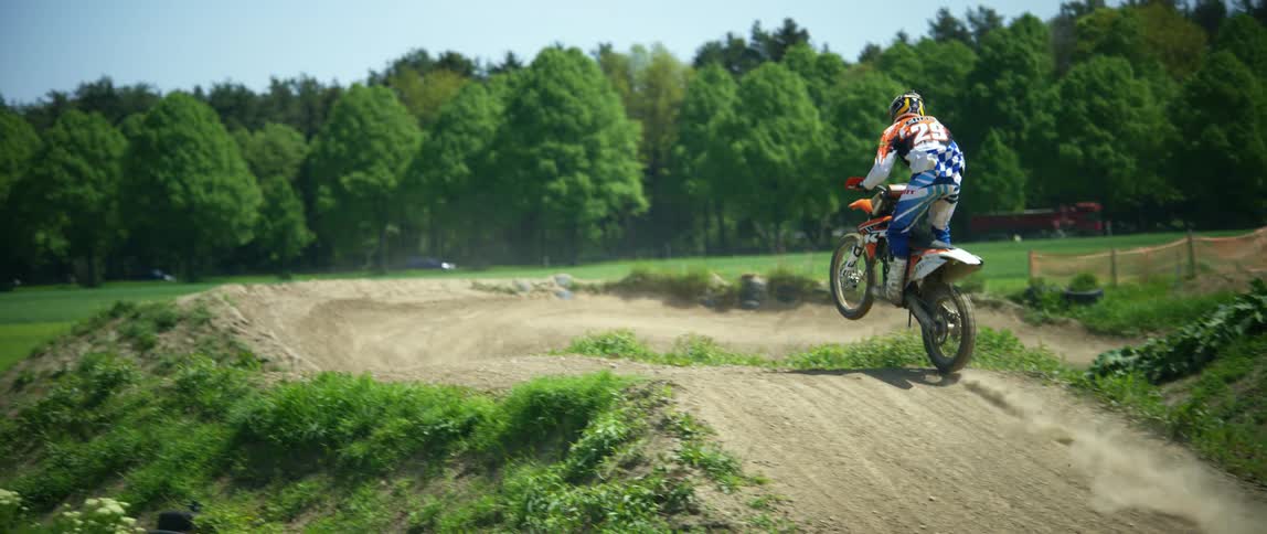 Person riding dirt bike on track
