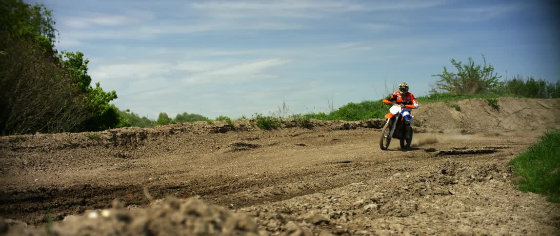 Person riding dirt bike on path