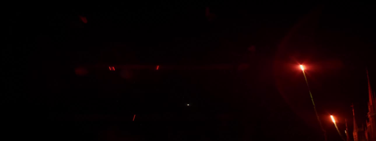 Cloroful fireworks shoot and explode in the sky at night