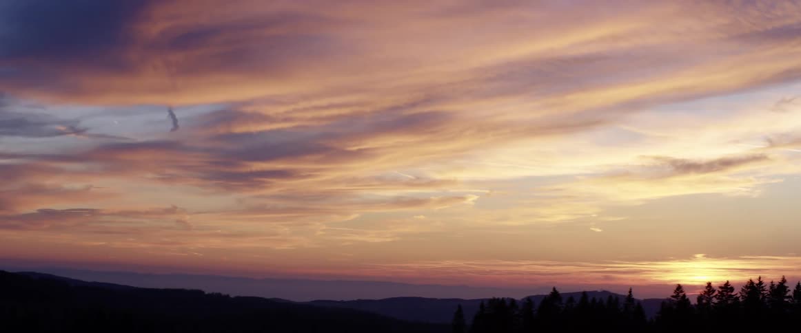 The sun is setting in the horizon