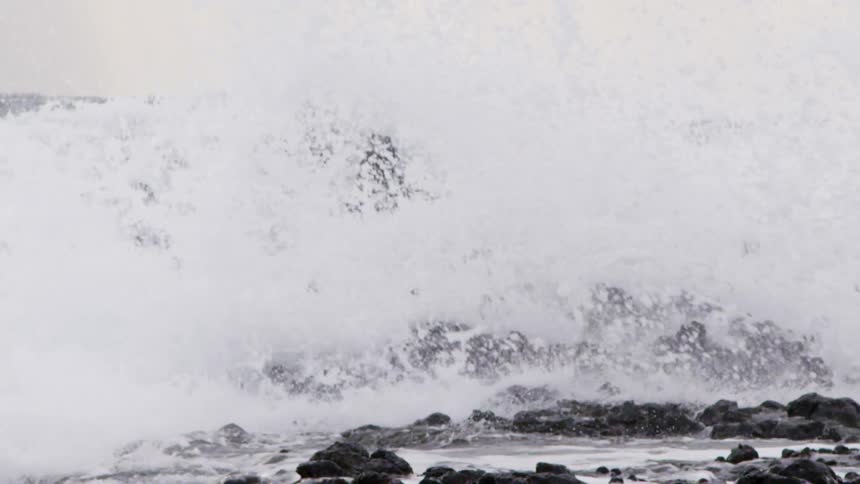 Waves crashing against rocks on coast