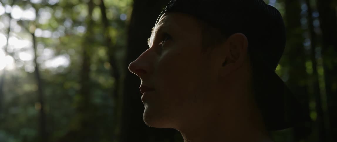 Man in a forest looking around him