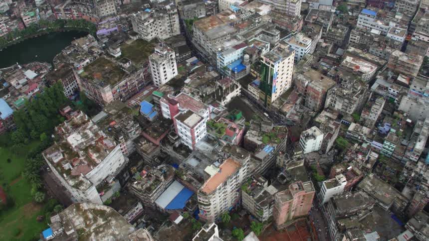 A city with building trees roads and vehicles