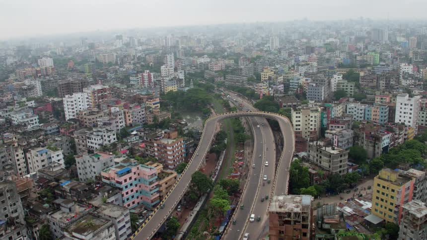 Cars are driving in a downtown city