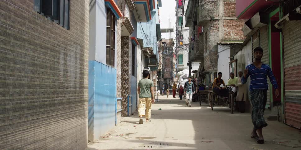 People walking in an alley in the slums