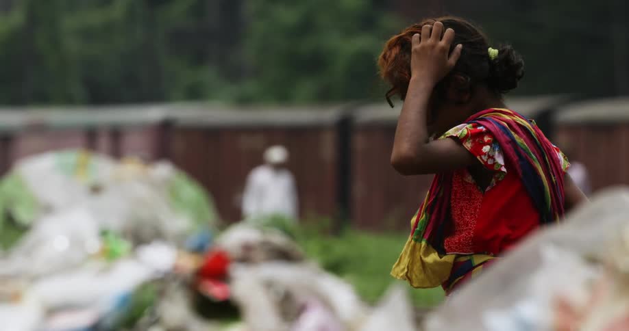 Young girl on a third world village on a landfill