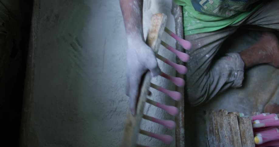 Young boy working on a balloon factory in a third world country