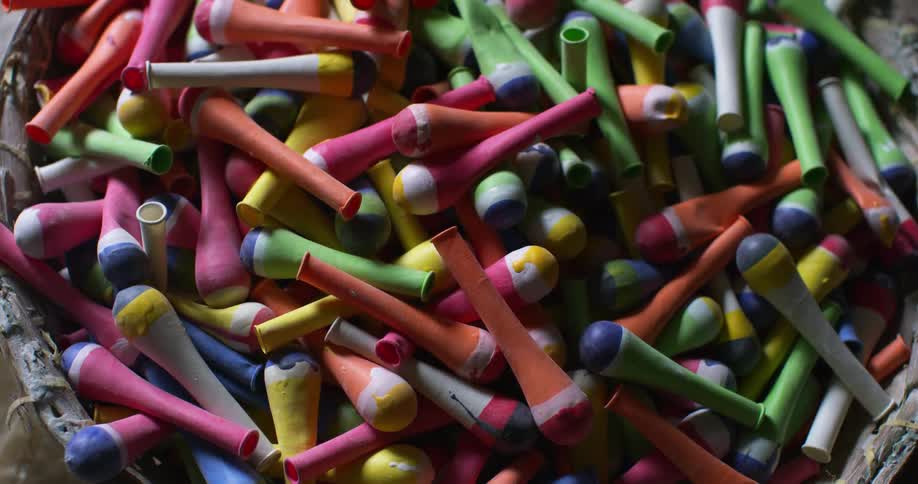 A basket filled with colorful uninflated balloons