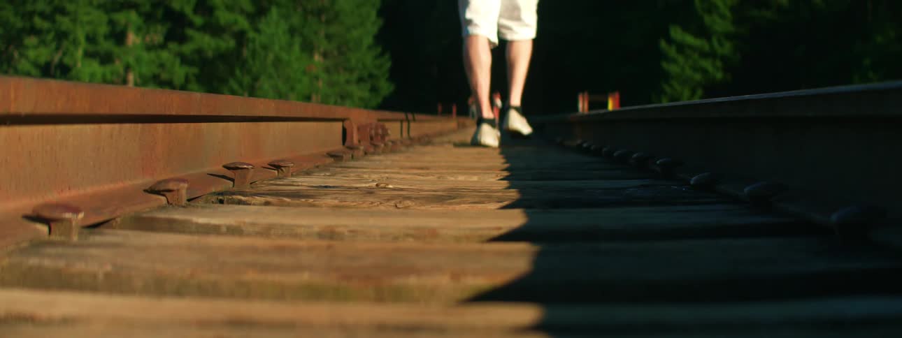 Person walking down old railroad tracks