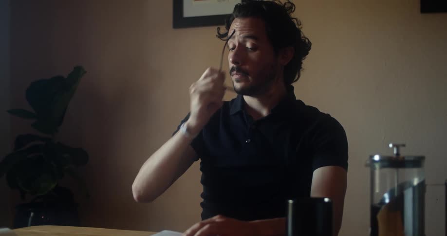 A man is reading a book indoors