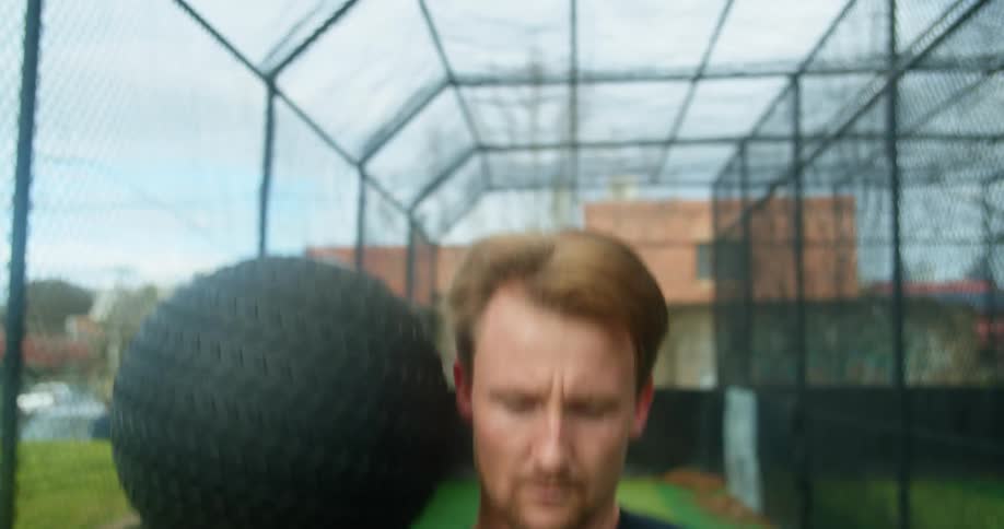 A man is exercising outdoors with a ball