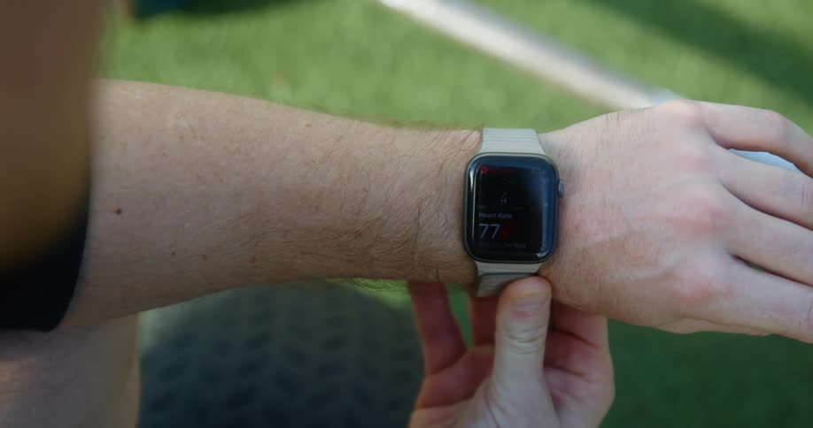 Man looks at his smartwatch