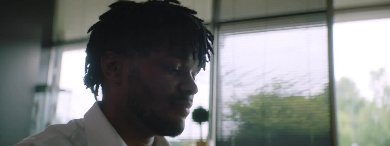 Young man types on a laptop working from home