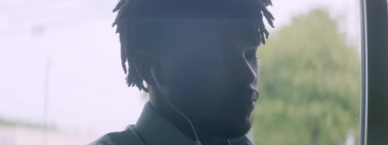 A man is using his cell phone near the window