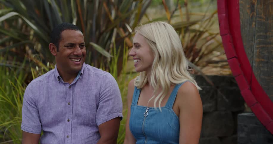 Young couple sitting outside talking and laughing