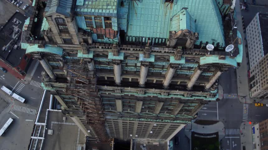 Aerial view of a high rise in a city with vehicles driving below
