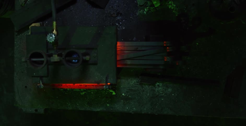 Pieces of wood are burned in an outdoor furnace at night