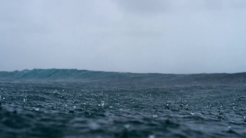 Raindrops falling on ocean