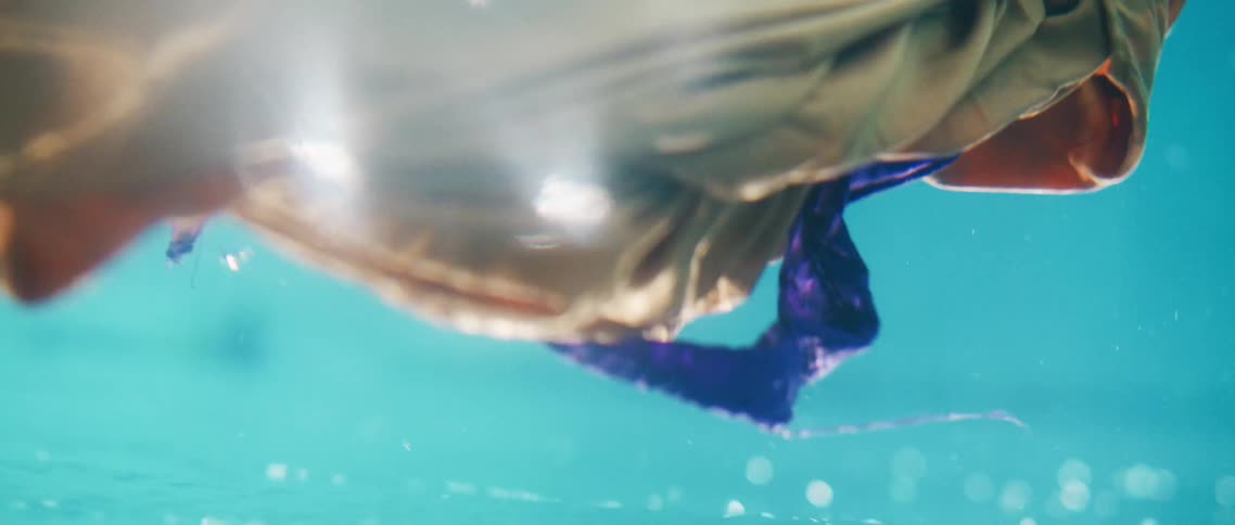 Some tan and blue cloth immersed and spinning in water