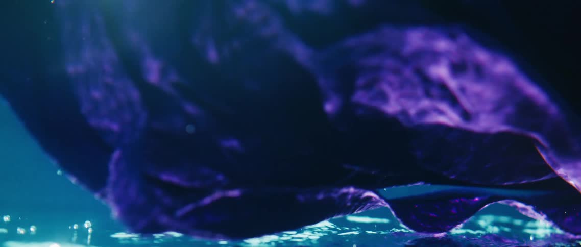 Purple material flowing underwater