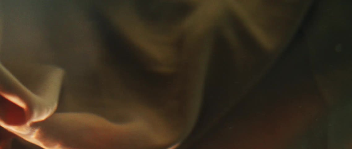 Brown and blue cloth underwater with light and bubbles