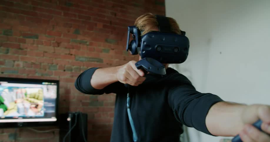 A man at home playing a virtual reality game