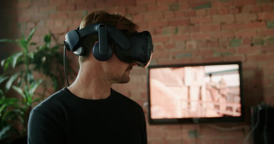 A man at home playing a virtual reality game