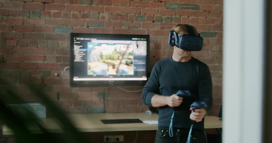 A man players a virtual reality game using virtual reality headset