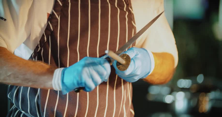 A man at home sharpens a knife