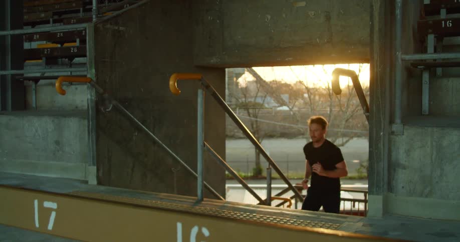 A man runs up the stairs into the stadium