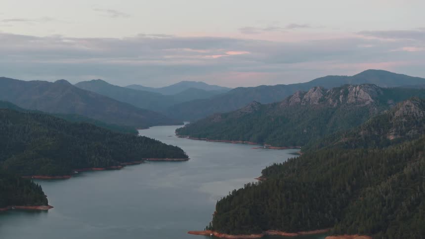 An aerial view of a mountain lake at dawn