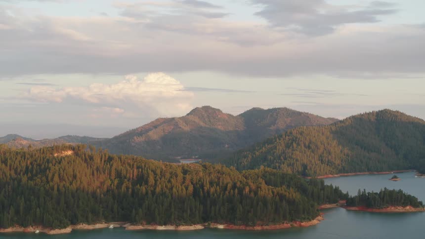 Conifer forest covers islets mountains and hills of river bend and surroundings