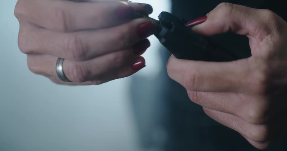Bullets are being loaded into a clip