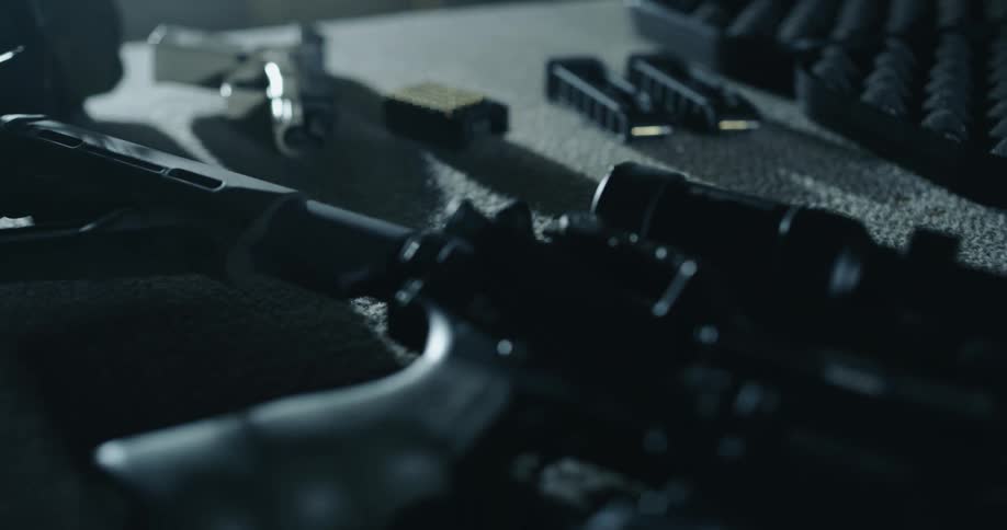 A table covered in firearms and firearm accessories