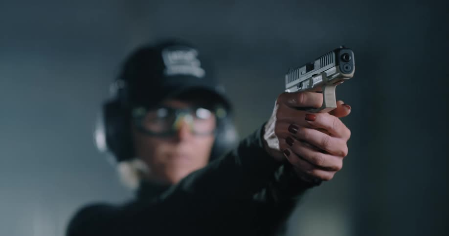 A woman shooting a gun