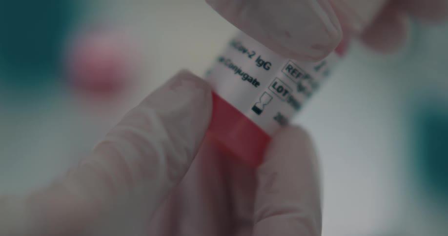 A person is showing the label on a bottle of medicine