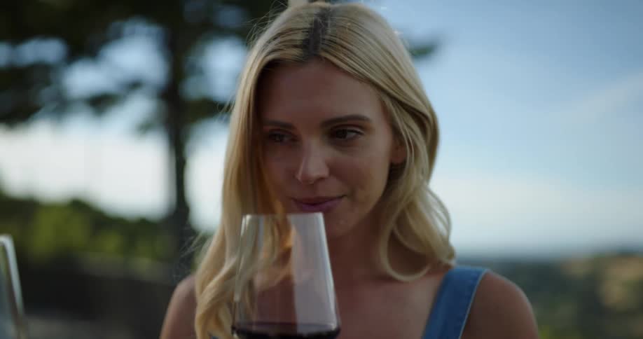 A smells a glass of wine