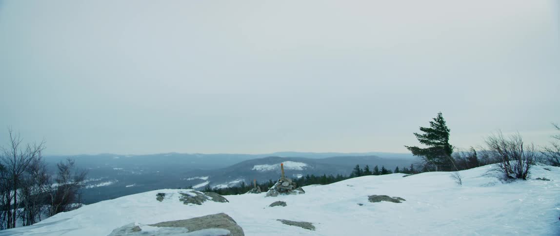 The winter wind sweeps across the frozen mountain top