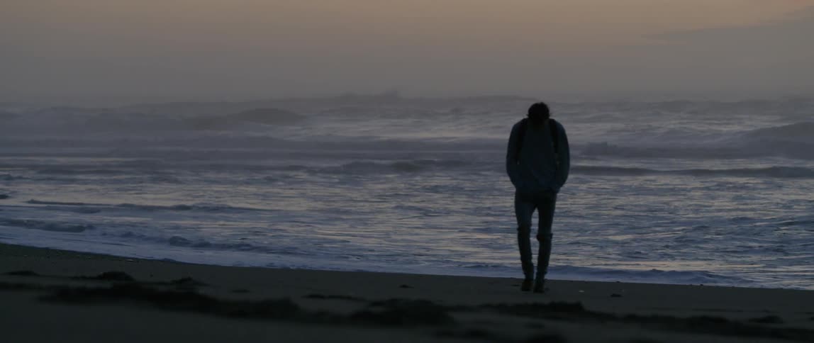 A man walks away from the ocean