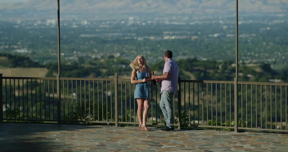 A couple outside on a patio drinking