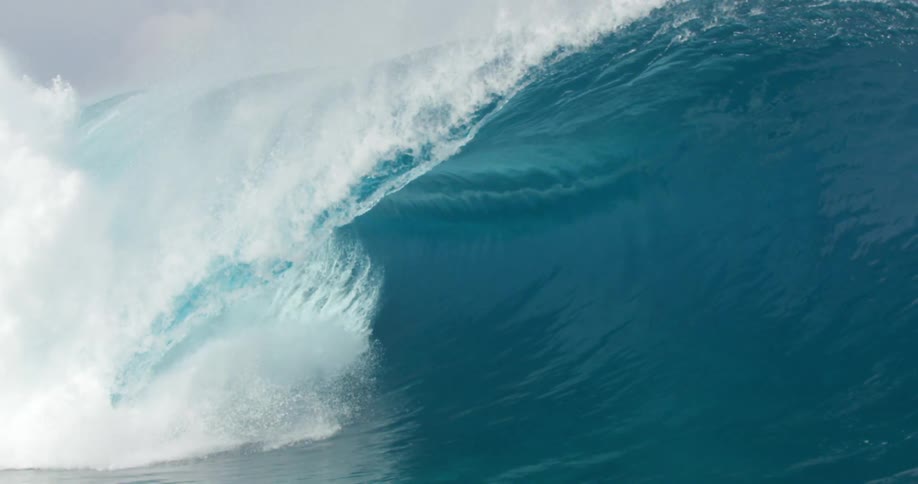 A large wave crashes in the ocean