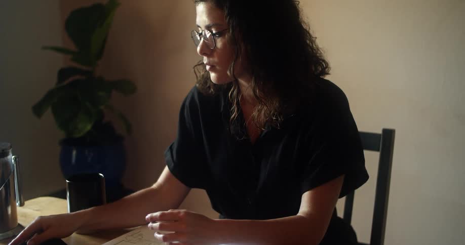 A woman is using her cell phone at the desk