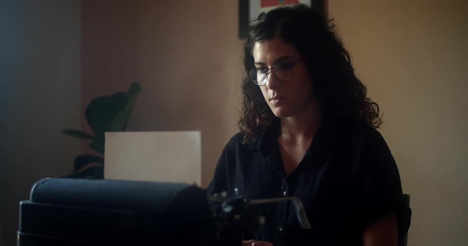 A woman is typing on a typewriter
