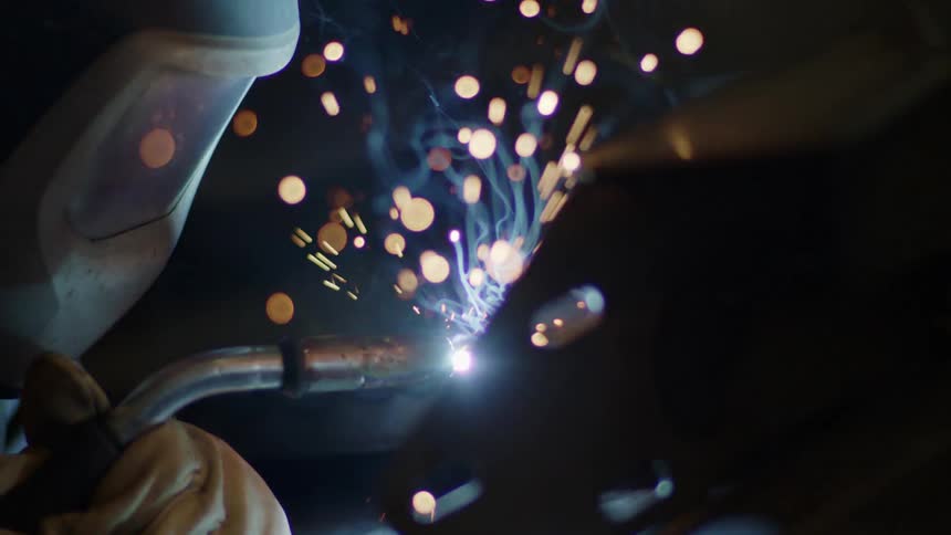 A person welding on a piece of metal