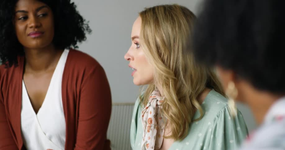 Three women sitting in a room talking